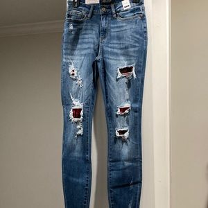 Judy Blue Size 1/25. New with tags. Distressed with buffalo plaid
